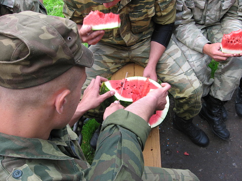 Eating of a water-melon. Soldiers eat a water-melon
