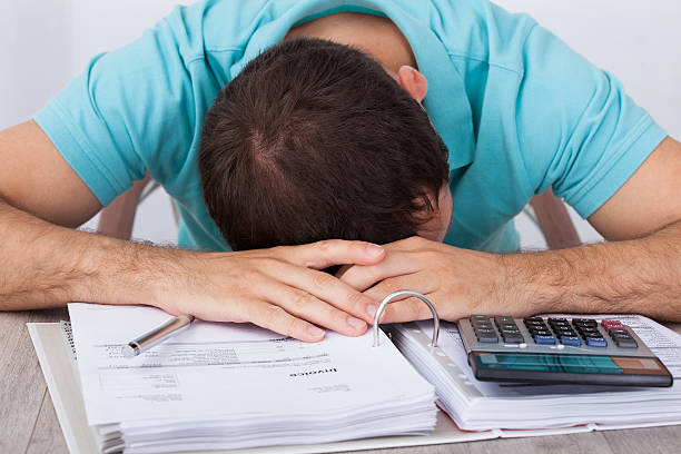 istock Tired Man With Bills And Calculator At Desk 508070451