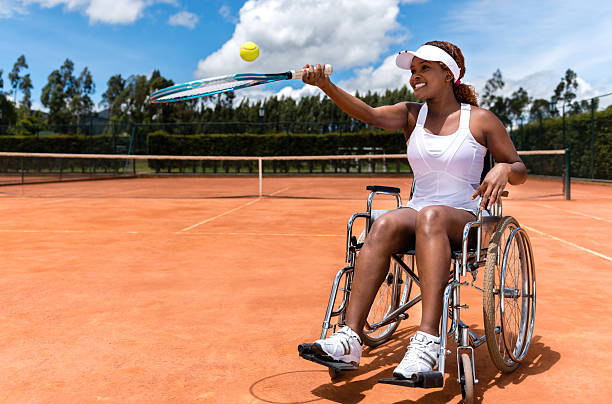 Paralympic tennis player Paralympic tennis player looking happy with a racket athlete with disabilities photos stock pictures, royalty-free photos & images