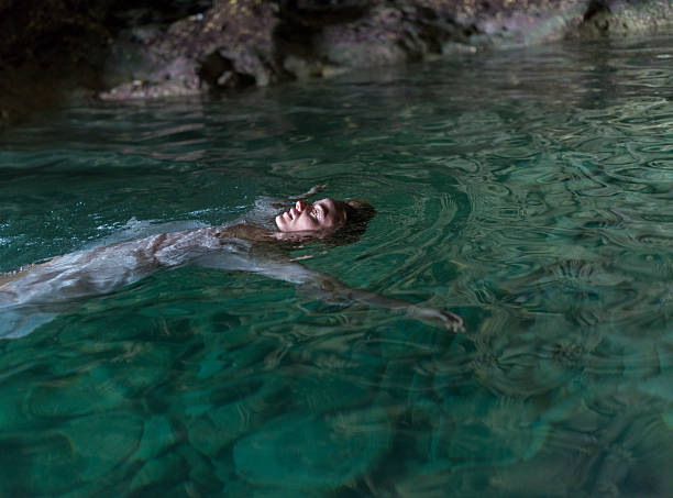 istock Young Woman Floating In A Cave 508071305