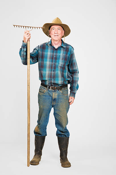 Senior farmer with rake full length