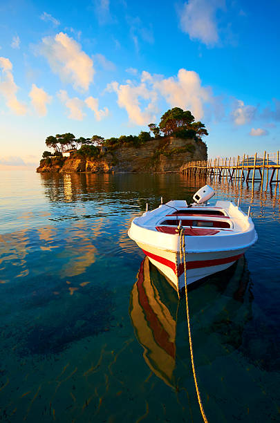 Early morning light falls on a small boat near the small island of Agios Sostis, on the eastern side of the Greek island of Zakynthos.