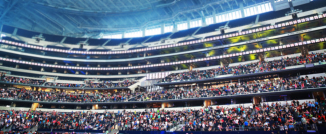 This is an out of focus shot of a crowd at a stadium.
