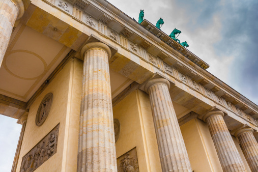 closeup view of brandenburg gate with columns and  horses in Berlin , Germany