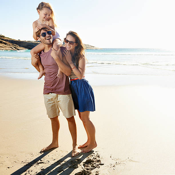 Young couple goes honeymoon horse riding on the beach in summer vacation.