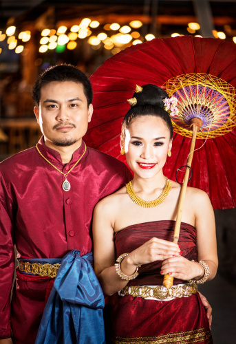 Traditionally dressed northern Thai couple in a modern setting in the evening.  Photographed with Nikon D800 full frame 36 mega pixel body and Nikon 105mm prime lens.