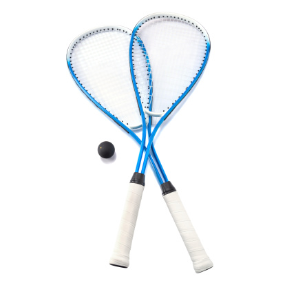 Close up of a squash rackets and balls isolated over white