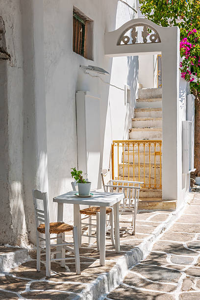Table and chairs outside a typical house in Mykonos stock photo
