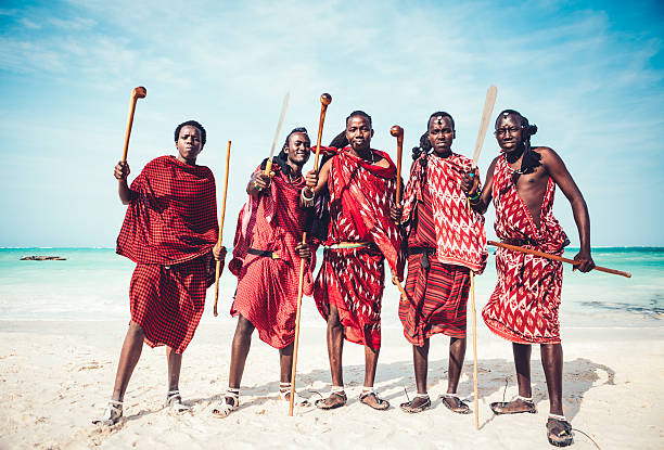 Masai Warriors Masai warriors in traditional clothing demonstrating their weapons on the beach (Zanzibar, Africa). masai stock pictures, royalty-free photos & images