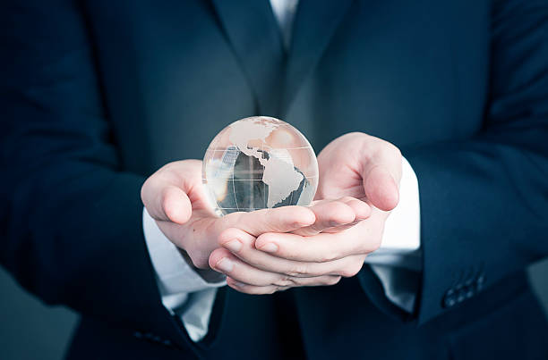 istock Businessman with the world glass globe in her hands 508092132