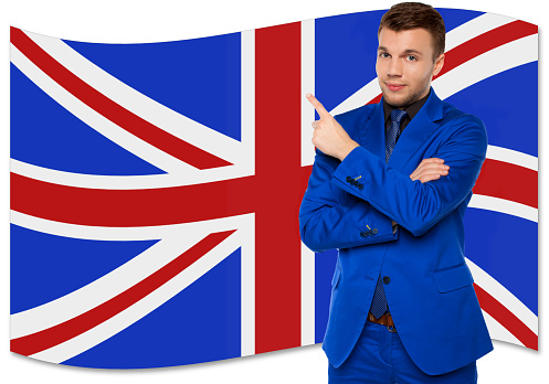 Elegant man in blue suit with British national flag. English language learning concept