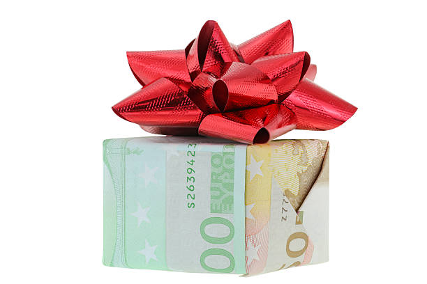 istock Gift box wrapped with Euro banknotes decorated with red ribbon 508093068