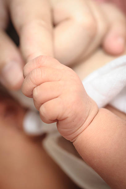 istock New-born baby keeps for a finger. 508093201