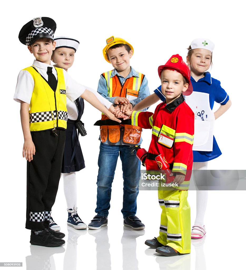 Kids and Professions Five kids standing with hands together, each one with a unique profession: policeman, sailor, firefighter, nurse and builder. Studio shot, isolated on white. Child Stock Photo