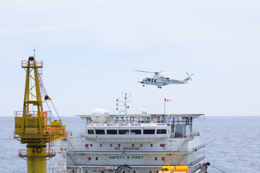 Helicopter landing on offshore oil rig, Passenger transfer to offshore oil and gas platform for work