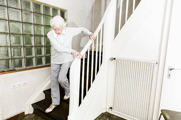istock senior woman walking down stairs 508094253