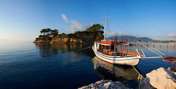 Morning light falls on a small boat tied up near the island of Agios Sostis, on the eastern side of the Greek island of Zakynthos.