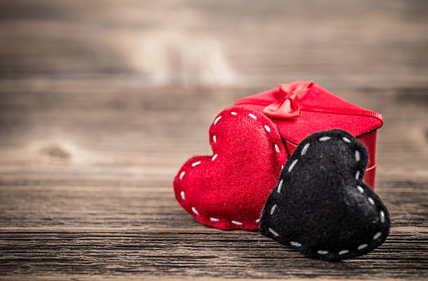 Divorce concept Divorce concept with red and black felt hearts on vintage wooden background felt heart shape small red stock pictures, royalty-free photos & images