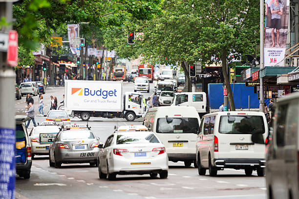 Budget car and truck rental Sydney, Australia - November 4, 2015: Color image of a truck rented from Budget seen on George Street of Sydney. People are crossing the street. Budget is an American rental car company, based in Los Angeles. st george street stock pictures, royalty-free photos & images