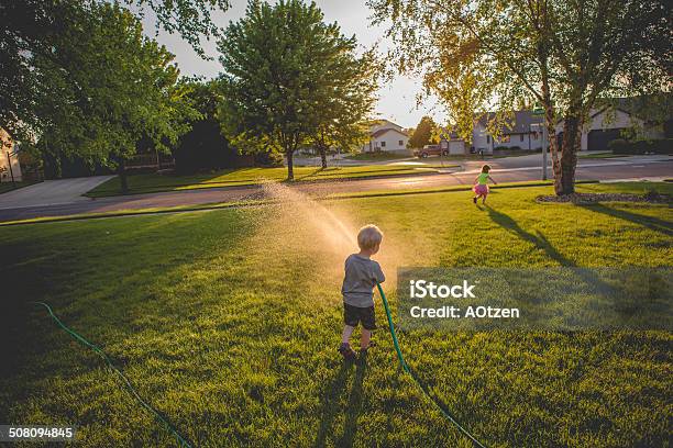 Playing With The Garden Hose Stock Photo - Download Image Now - Garden Hose, 4-5 Years, Boys