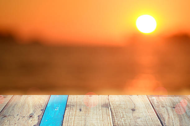 istock Blur tropical sunset beach with old empty wood table background. 508095296