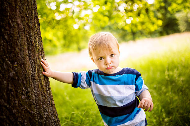 istock Baby Boy leaning agianst Tree 508095863