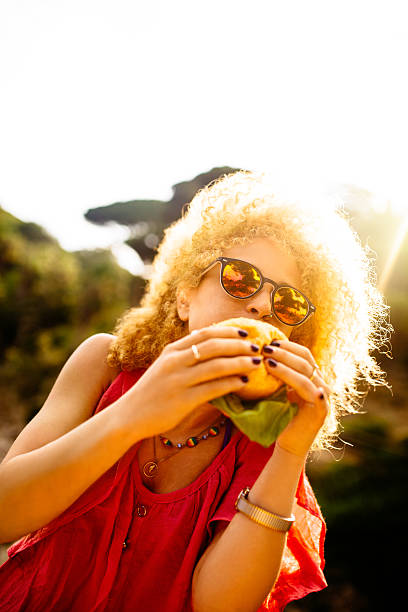 istock Girl Eating Hamburger 508095887