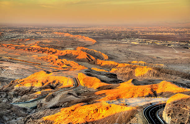 Jabal Hafeet mountain on the border between Emirates and Oman Jabal Hafeet mountain on the border between Emirates and Oman jebel hafeet stock pictures, royalty-free photos & images