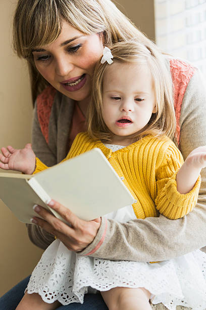 istock Mother reading to daughter with down syndrome 508096881