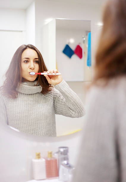 istock Woman brushing her teeth 508097354