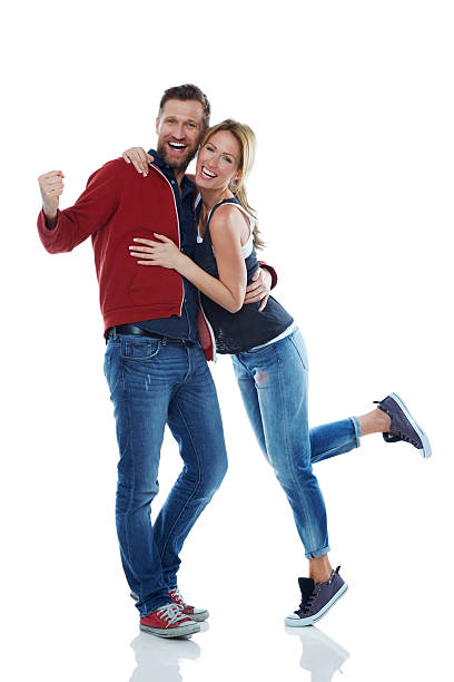 istock Young couple together cheering on white 508097655