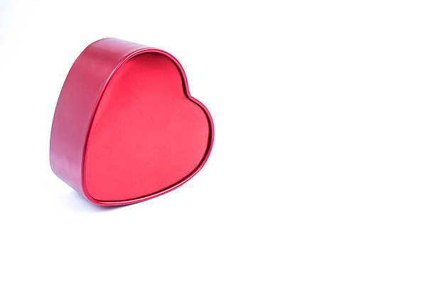 red heart shape metal box for Valentine's Day on white background with copy space