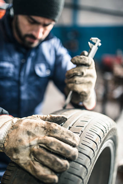 istock tire repairer checking the tire integrity 508098112