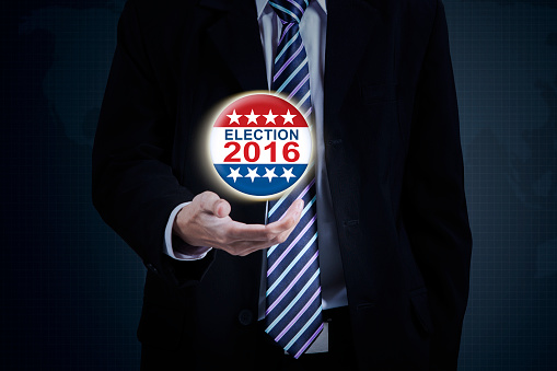 Image of businessman hand holding election symbol with number 2016