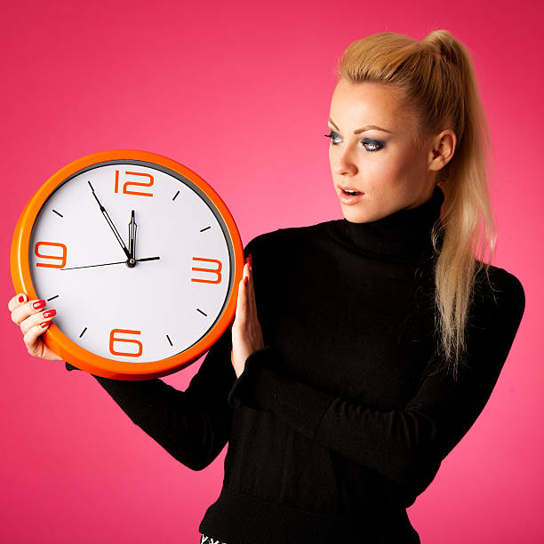 istock Worried woman with big orange clock gesturing delay, rush, nervous 508098778