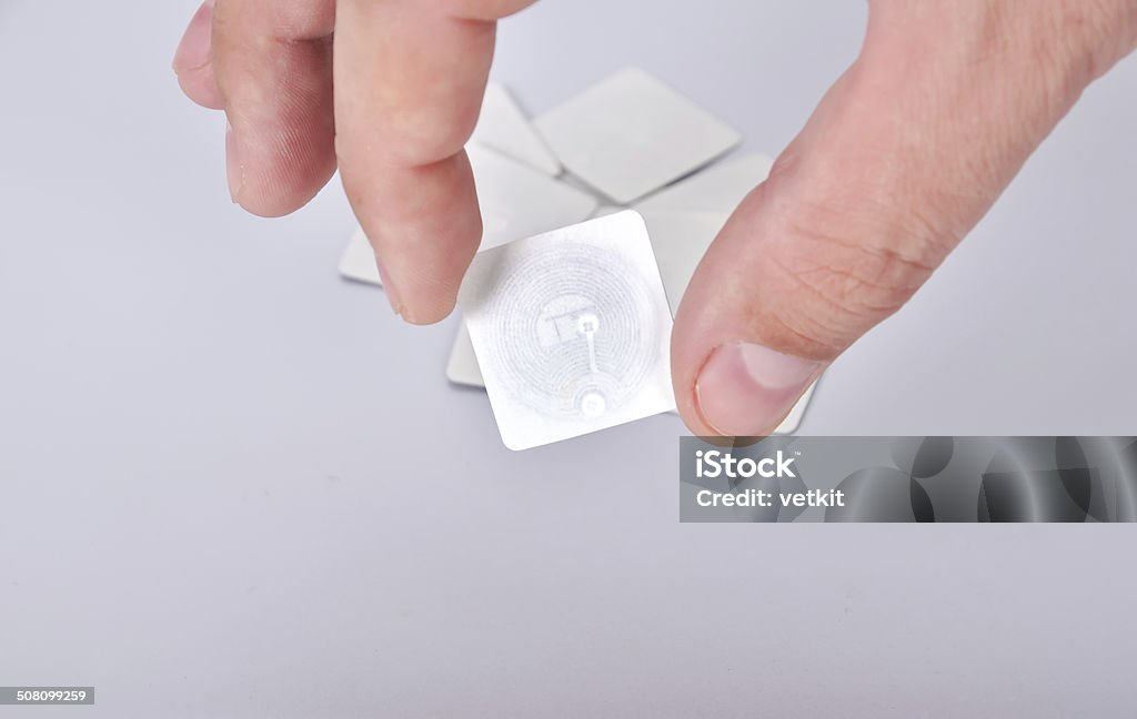 rfid tags hand holding rfid tags, close up Radio Frequency Identification Stock Photo