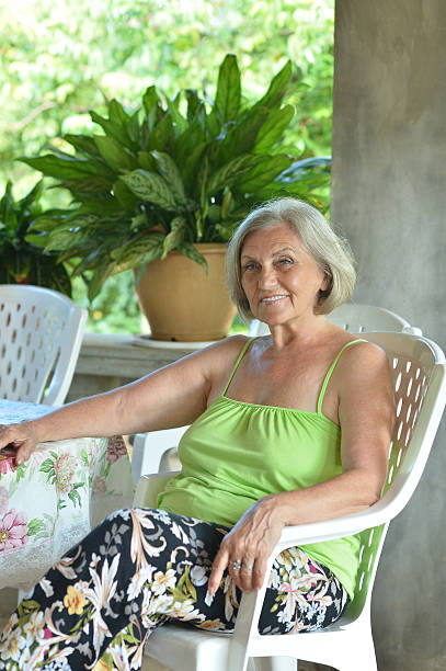 istock Older woman resting at tropical resort 508099378