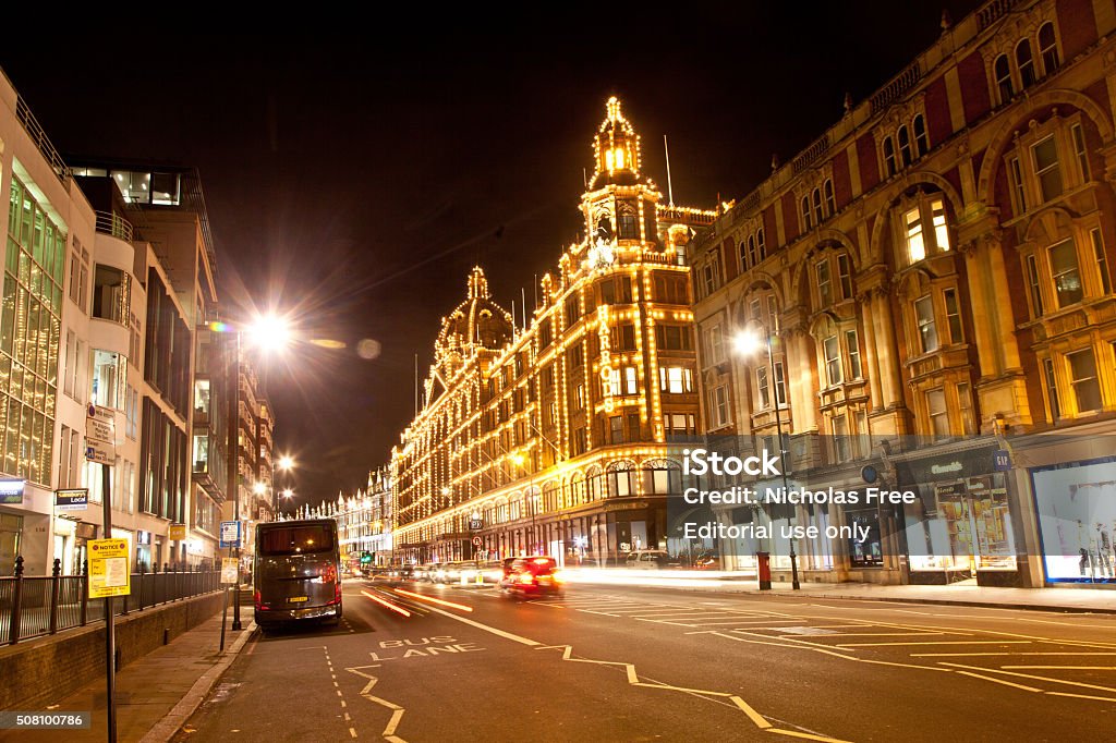 Harrods Store Knightsbridge London London, UK - December 9, 2015: The Harrods Store in the Knightsbridge area of London on a winters evening is highlighted by it distinctive lights. Building Exterior Stock Photo