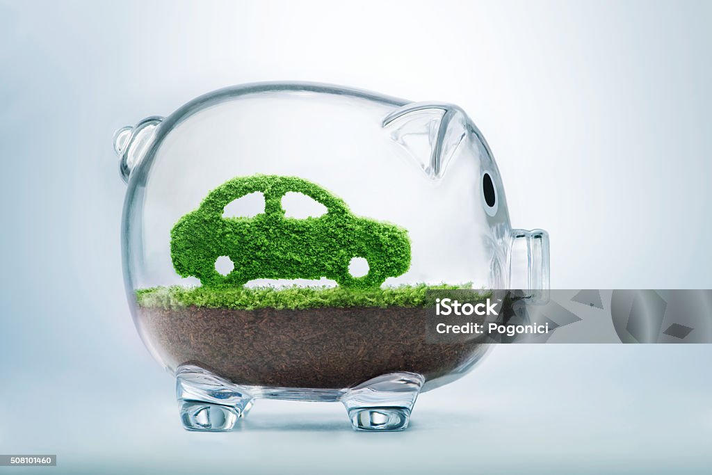 Green energy car Green energy concept with grass growing in shape of car inside transparent piggy bank Car Stock Photo