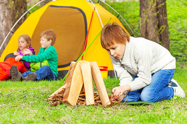 istock Boy prepares bonfire in forest with other children 508102492