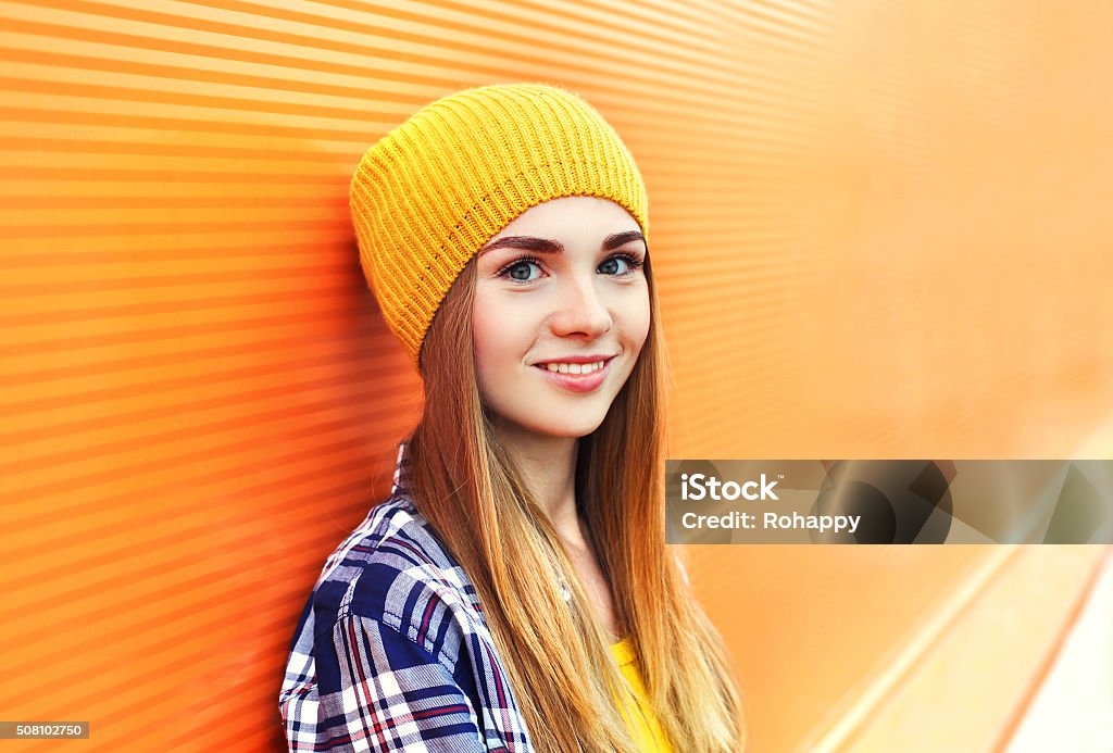 Portrait closeup beautiful young girl in yellow hat over colorful Portrait closeup beautiful young girl in yellow hat over colorful background Teenager Stock Photo