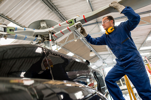 Mechanic fixing the propeller on a helicopter