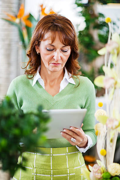 istock Woman using touchpad in a flower shop. 508122477