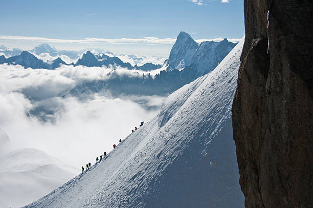 Group of climbers on the ridge of the French Alps Group of climbers on the ridge of the French Alps, Chamonix, Mountain top station Aiguille du Midi, France leisure activity french culture sport high angle view stock pictures, royalty-free photos & images