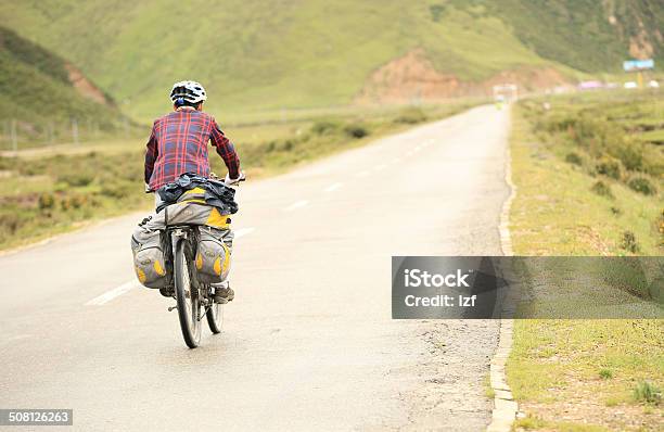 Mountain Bike Rides Along The Road Tibet China Stock Photo - Download Image Now - Achievement, Activity, Adult