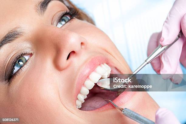 Dentist Working On Girls Teeth Stock Photo - Download Image Now - Dentist, Women, Adult