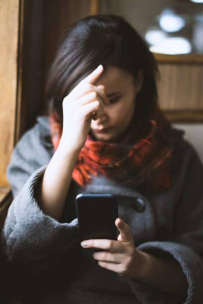 istock Young woman styling her hair by using her phone 508126590