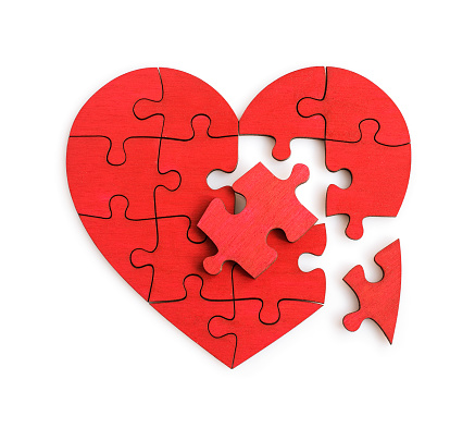 Puzzle of the heart shape isolated on the white