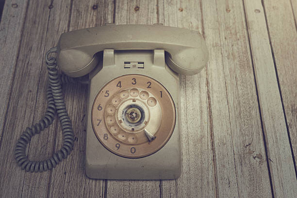istock old telephone on wooden table. vintage color. 508127848