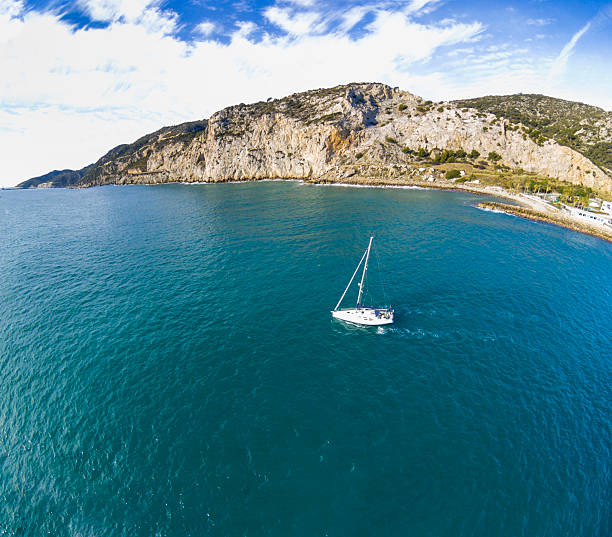 sailboat sea aerial view beach mountain copy space aerial view of a sailboat yacht rock music stock pictures, royalty-free photos & images